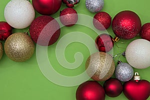 Christmas tree decorations in various colors on a green background with copy space. New Year`s scene setting