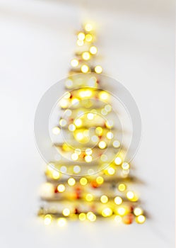 Christmas tree defocused with lights glowing on white background