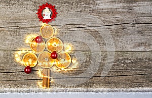 Christmas Tree From Dried Oranges With Fairy Lights And Baubles.