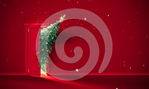 Christmas tree enters the door. Christmas is here concept on red background with copy space. photo