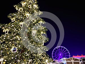 Christmas tree with Ferris wheel in the background at a Christmas market photo