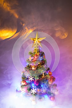 Christmas tree with festive lights, background with smoke