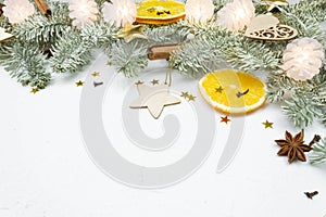 Christmas tree fir branch, holiday decor on white snow with copy space. Festive minimal eco background. Macro close up