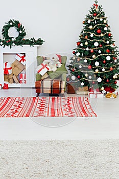 Christmas tree with fireplace interior of white room new year decoration garland gifts