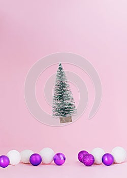 Christmas tree flying.coming down in baubles vivid purple and snowy white.Holidays design