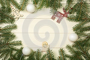 Christmas tree frame branches, balls and christmas toys on wooden background with copy space. Horizontal template for design