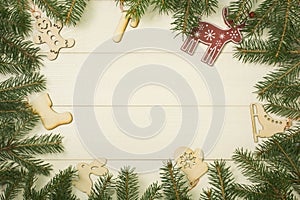 Christmas tree frame branches and christmas toys on wooden background with copy space. Horizontal template for design