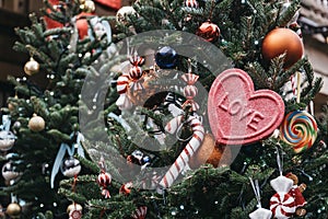 Christmas tree full of traditional Christmas baubles, decorations and a pink