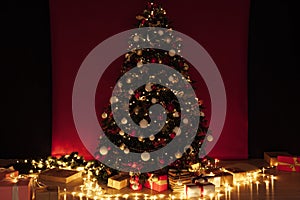 Christmas tree garland lights with New Year`s Eve gifts