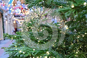 Christmas tree with garlands against a beautiful bokeh background.