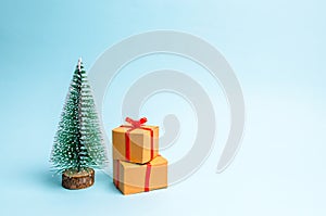 Christmas tree and gift on a blue background. Minimalism. Family holiday, Christmas and New Year. Sale of gifts. Sell-out.
