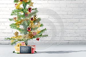 Christmas tree with gift box and Boxing Day text on the blackboard