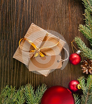 Christmas tree with gift box and decorations on wooden background