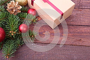 Christmas tree with gift box and decorations on wooden background space for lettering