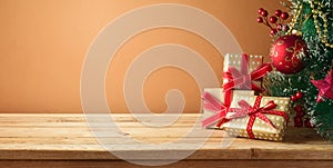 Christmas tree and gift boxes on wooden table. Background for product montage display