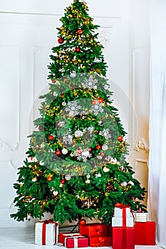 Christmas tree with gifts in Christmas living room. Beautiful New Year decorated classic home interior. Winter background