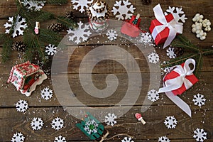 Christmas tree with gifts and decorations snowflakes on the wooden background. Christmas and New Year concept. Flat lay. Top view.