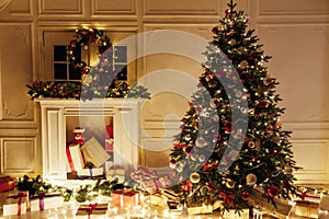 Christmas tree with gifts of garland lights for the new year in the interior of the night room as a backdrop