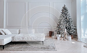 Christmas tree with gifts in white living room