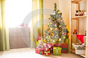 Christmas tree with gifts in a white room. Christmas morning