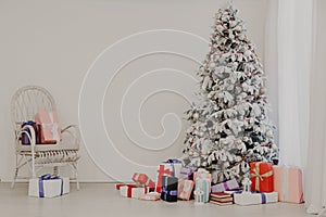 Christmas tree with gifts in the white room of the new year Santa