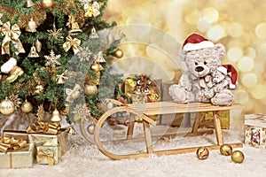 Christmas tree with a golden ornaments , Teddy bears, a sledge and a presents. Vintage, sepia colour