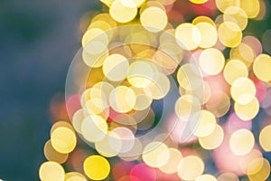 Christmas tree with golden and red decorations and lights, blurred abstract holiday background