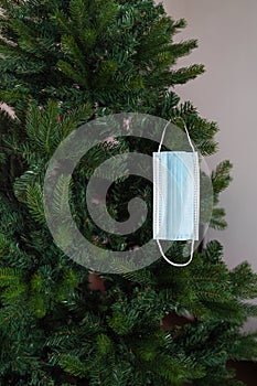 Christmas tree with hanging Covid mask