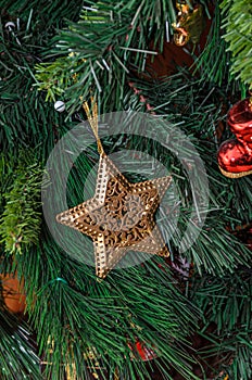 Christmas tree hanging ornament, golden star, close up