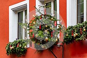 Christmas tree hanging on a red house wall in medieval town of Rothenburg ob der Tauber, Bavaria, Germany