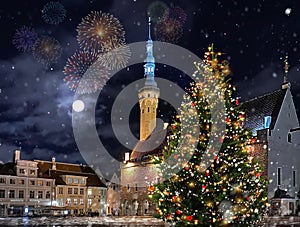 Christmas tree illuminated decoration  on hall town square in winter  Tallinn old town medieval city ,moon on night blue sky snow