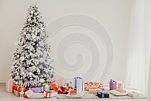 Christmas tree in the Interior of the white room gifts new year holiday