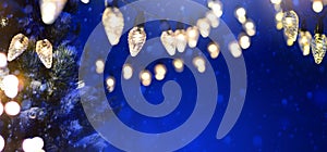 Christmas Tree light over Snowy dark blue sky background