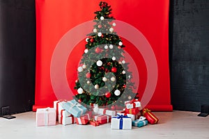Christmas tree with lights garlands gifts decor of the house new year