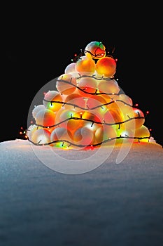 Christmas tree lights on snowballs heap
