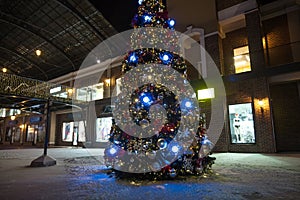 Christmas tree in lights on street at night