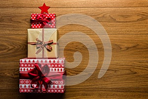 Christmas tree made of beautifully wrapped presents on wooden background photo
