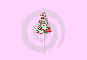 Christmas tree made of candy on a pink background.