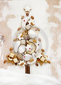 Christmas tree made from different kinds of homemade cookies on a white background.