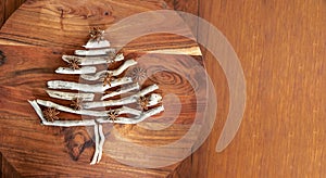 Christmas tree made of dry wood over wooden background, copy space, xmas and new year symbol, decoration