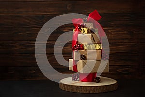 Christmas tree made from gift boxes with decorations against brown wooden background. Copy space.  Merry christmas and happy new