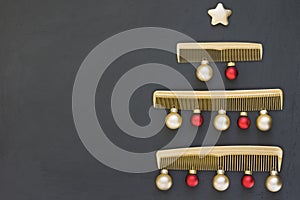 Christmas tree made of gold combs on a dark gray background. New year`s template for a hair salon with space for text.