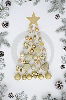 Christmas tree made of New year decorations,golden balls,heart,candle, bell and winter things on white background with