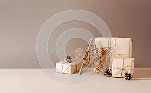 Christmas tree made of paper craft origami gifts packed in plain paper wooden star on a beige trendy background.