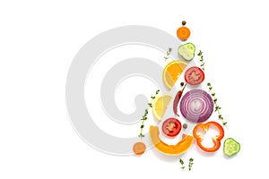 Christmas tree made of pieces of vegetables and fruits on a white background. The concept of vegan and vegetarian food. Top view,