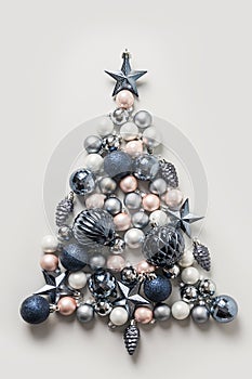 Christmas tree made of pink and blue balls on grey. Xmas. Flat lay, top view. Holiday Greeting card. Happy New Year.