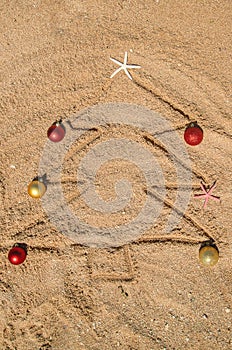 Christmas tree made of shells in the sand. Selective focus