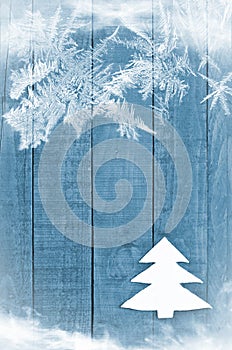 Christmas tree made from white felt on wooden, blue background. Snow flaks image. Christmas tree ornament, craft