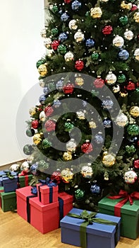 Christmas tree with many differently colored christmas balls photo