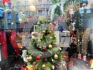 Christmas  tree market in window vitrines trees decoration reflection on street vitrines snowflakes and gold confeti holiday st photo